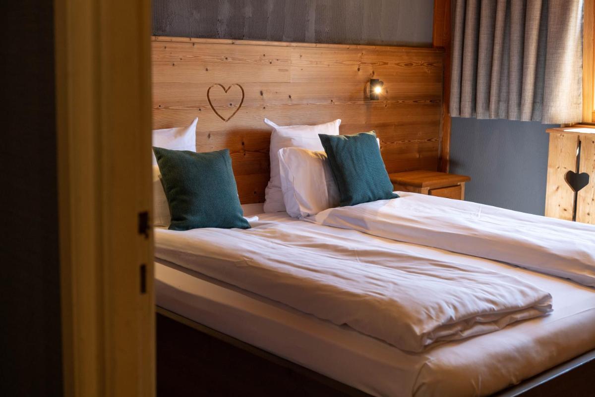 Un ou plusieurs lits dans un hébergement de l'établissement Chalet Hôtel & Spa Le Collet