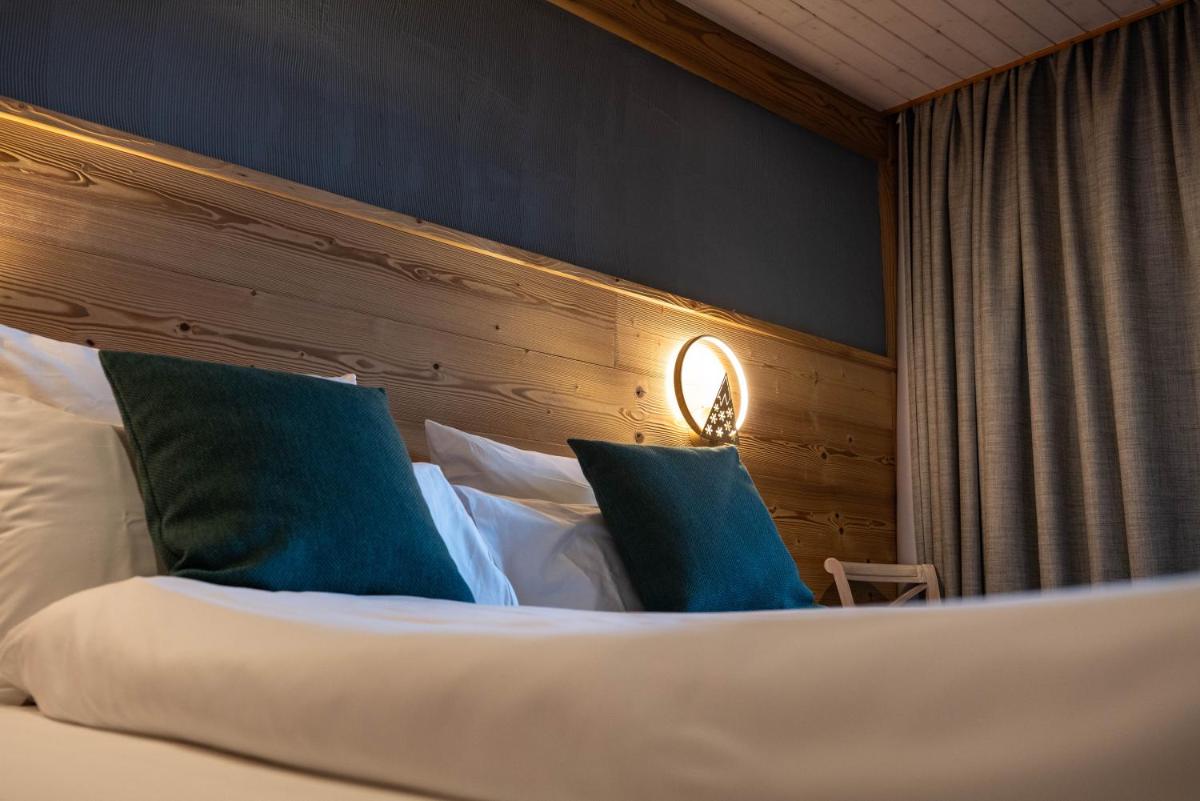 Un ou plusieurs lits dans un hébergement de l'établissement Chalet Hôtel & Spa Le Collet