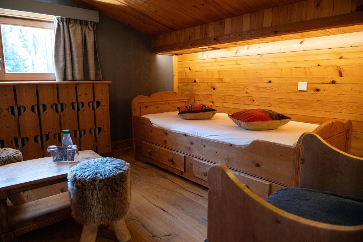 Un ou plusieurs lits dans un hébergement de l'établissement Chalet Hôtel & Spa Le Collet