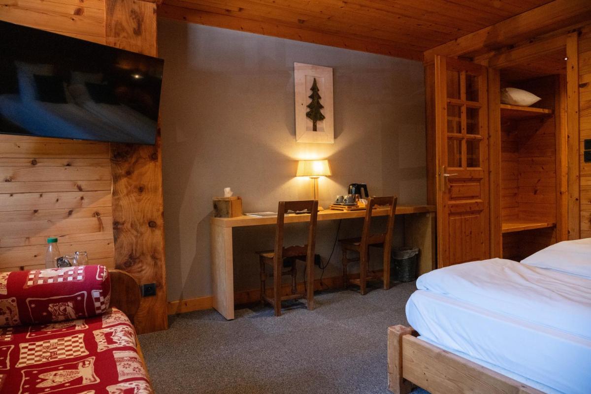 Un ou plusieurs lits dans un hébergement de l'établissement Chalet Hôtel & Spa Le Collet