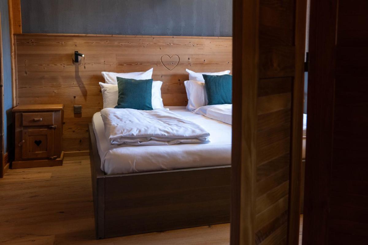 Un ou plusieurs lits dans un hébergement de l'établissement Chalet Hôtel & Spa Le Collet