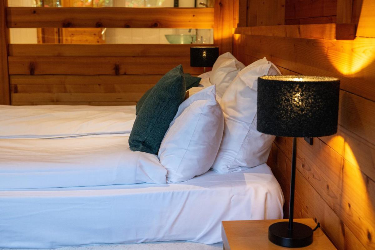 Un ou plusieurs lits dans un hébergement de l'établissement Chalet Hôtel & Spa Le Collet