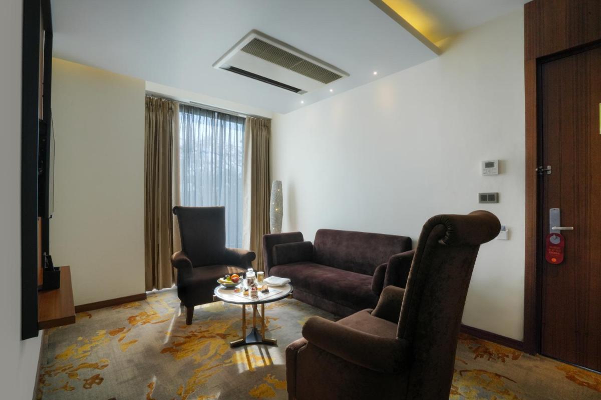 a living room with a couch and a table at Hyatt Centric Rajpur Road Dehradun in Dehradun
