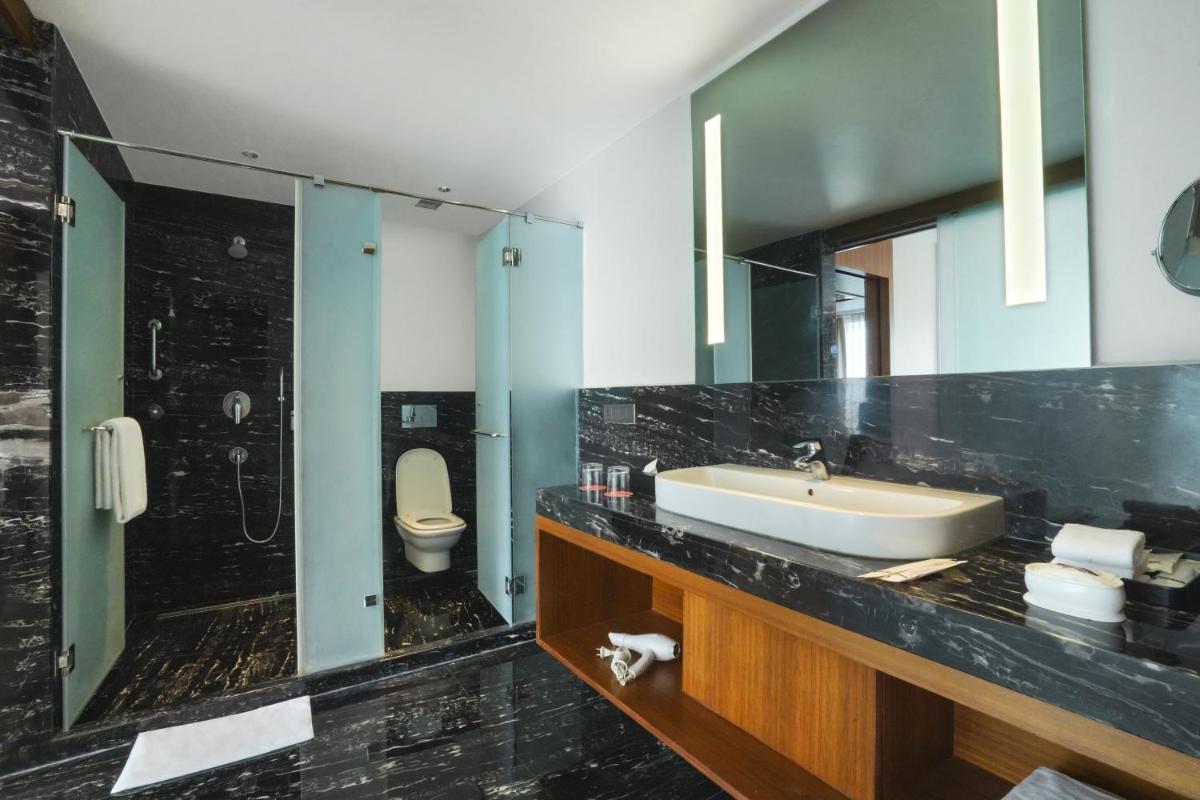 a bathroom with a sink and a toilet at Hyatt Centric Rajpur Road Dehradun in Dehradun