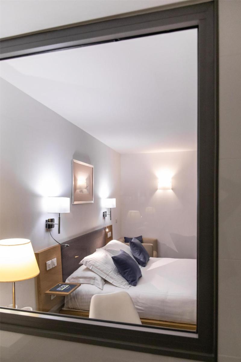 Un ou plusieurs lits dans un hébergement de l'établissement Best Western Premier Hôtel du Vieux-Port