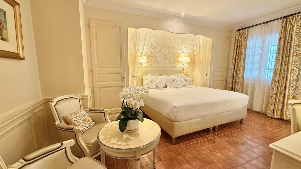 Un ou plusieurs lits dans un hébergement de l'établissement Auberge de Cassagne & Spa