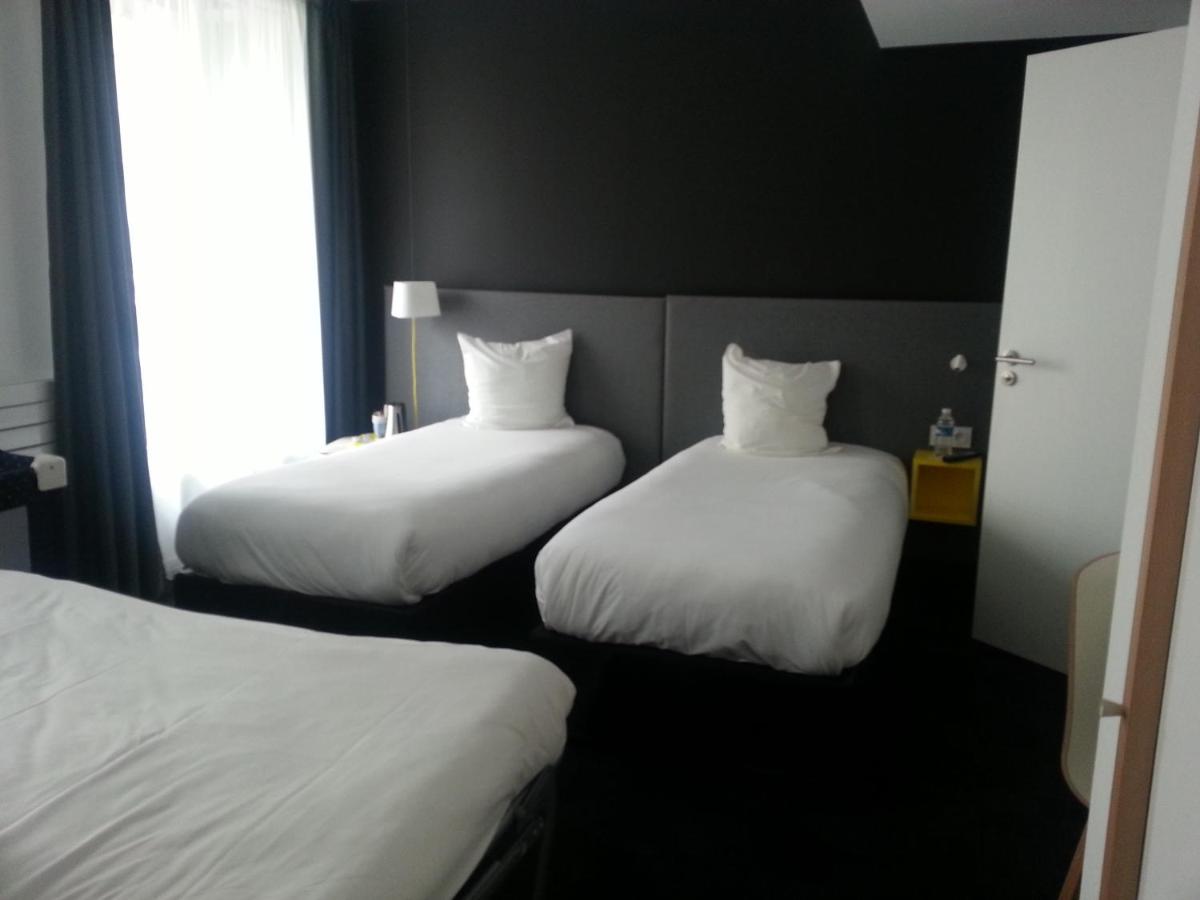 Un ou plusieurs lits dans un hébergement de l'établissement Kyriad Hotel Brest