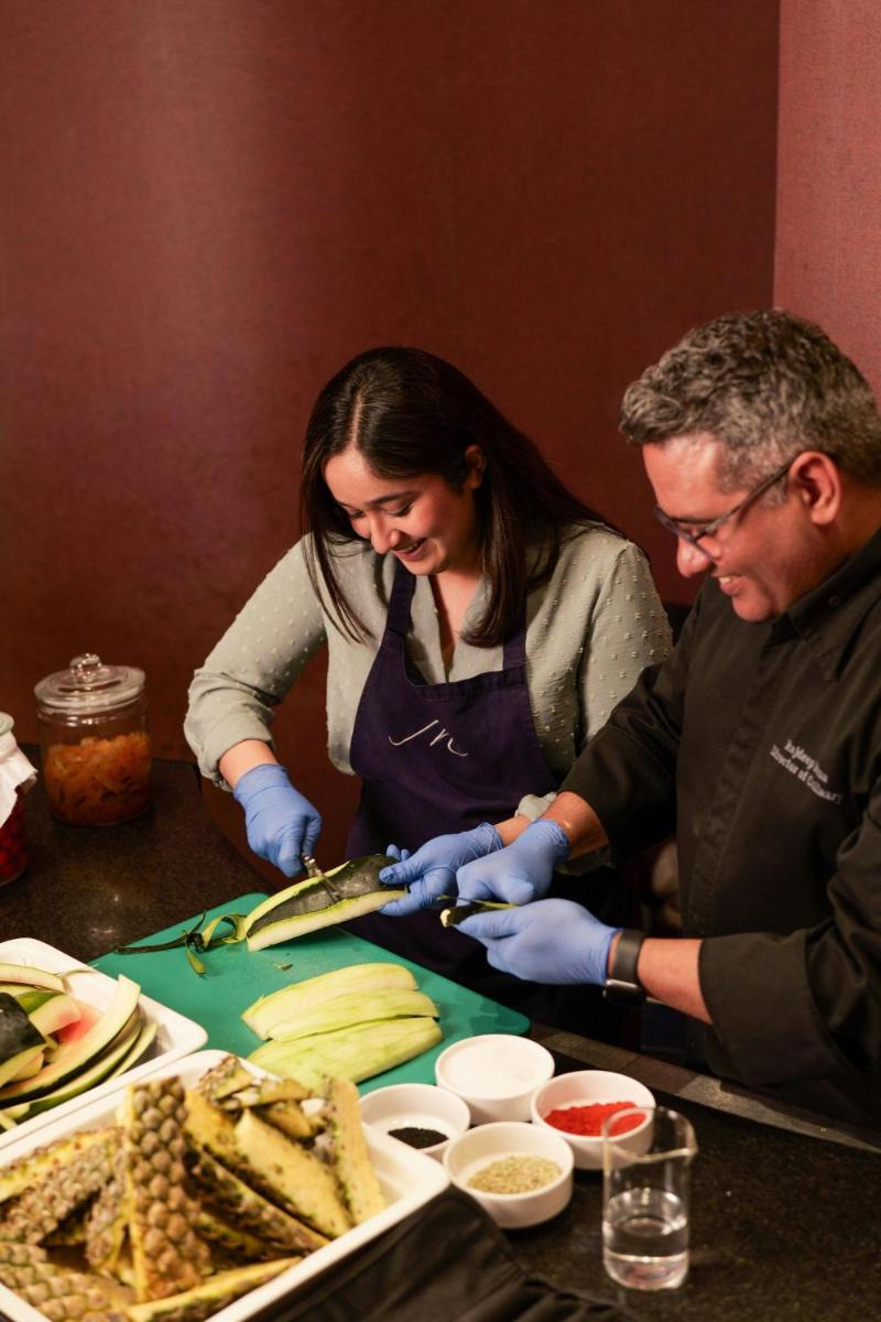a man and woman preparing food on a table at The Westin Pune Koregaon Park in Pune
