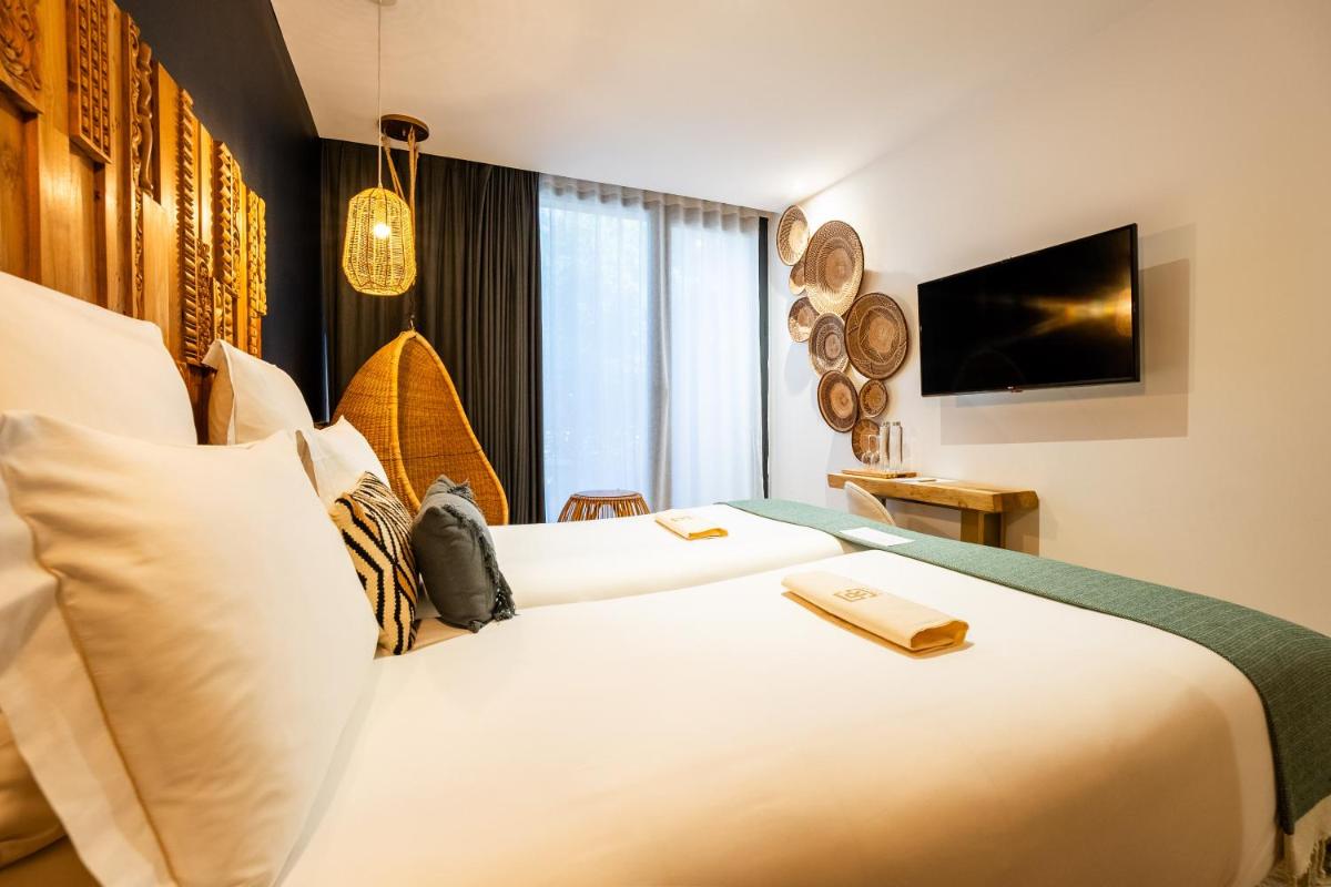 Un ou plusieurs lits dans un hébergement de l'établissement Hôtel Le Saint Remy & Spa
