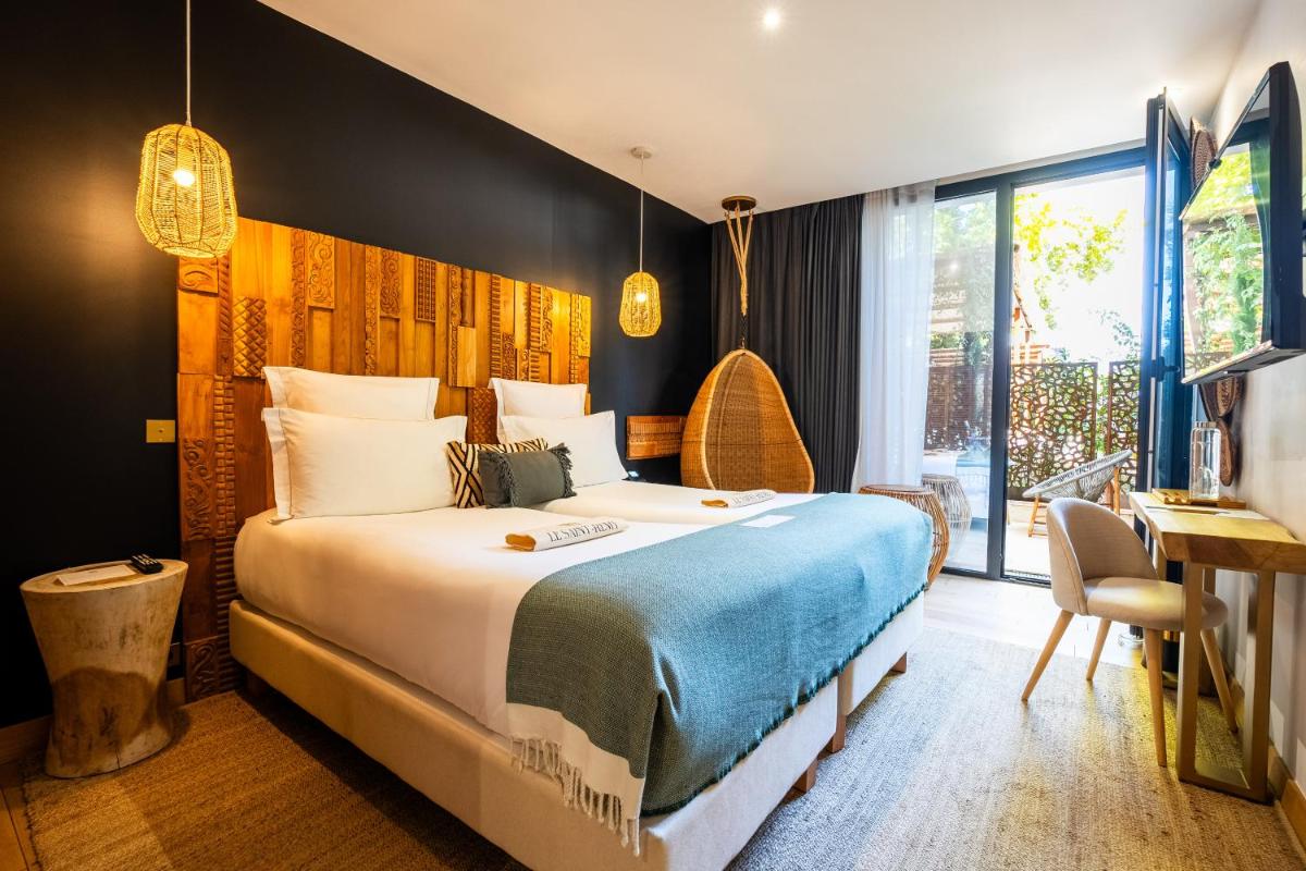 Un ou plusieurs lits dans un hébergement de l'établissement Hôtel Le Saint Remy & Spa