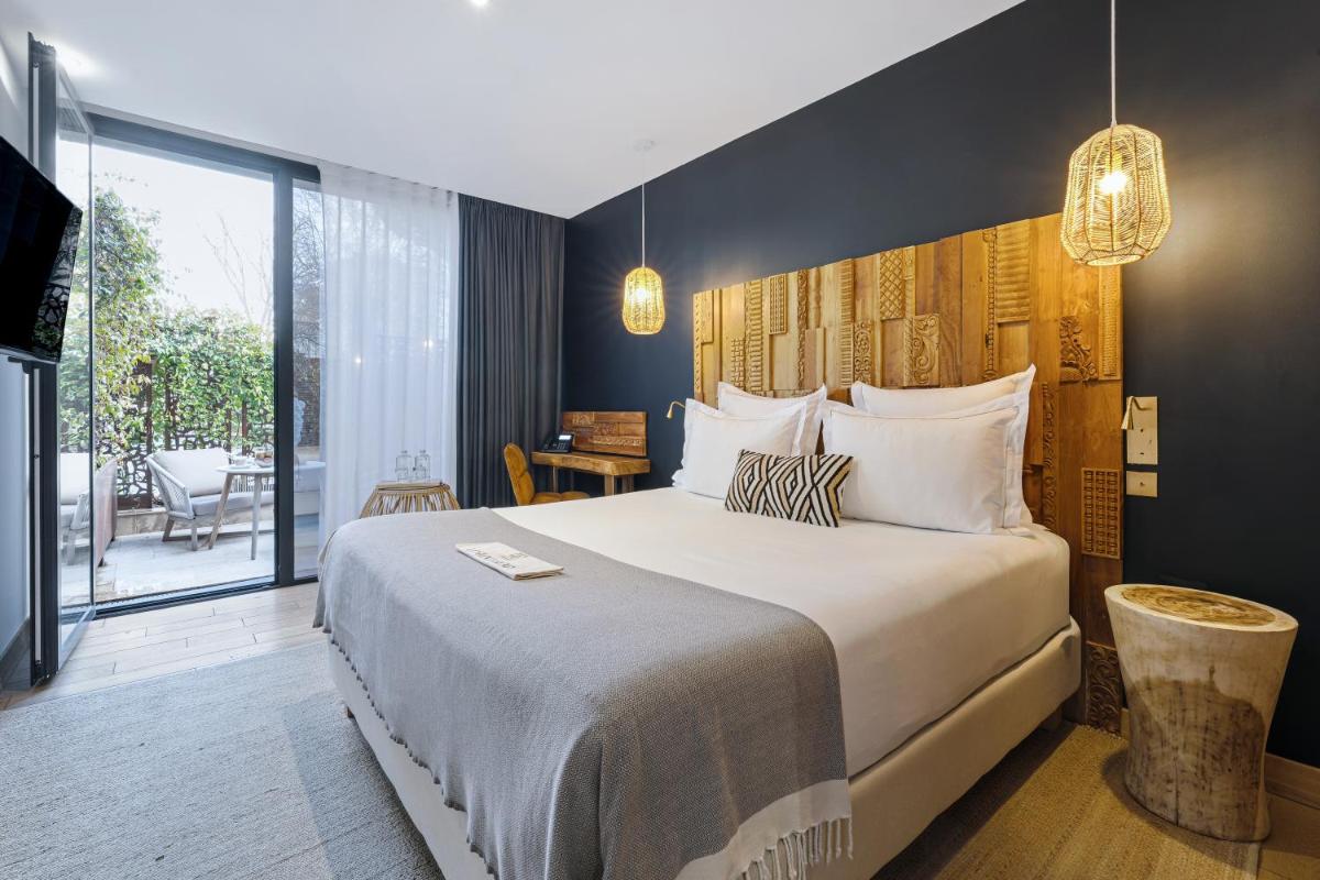 Un ou plusieurs lits dans un hébergement de l'établissement Hôtel Le Saint Remy & Spa