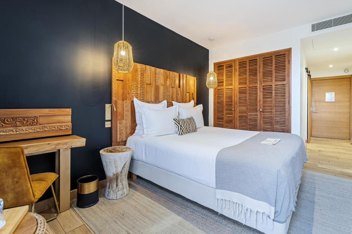 Un ou plusieurs lits dans un hébergement de l'établissement Hôtel Le Saint Remy & Spa