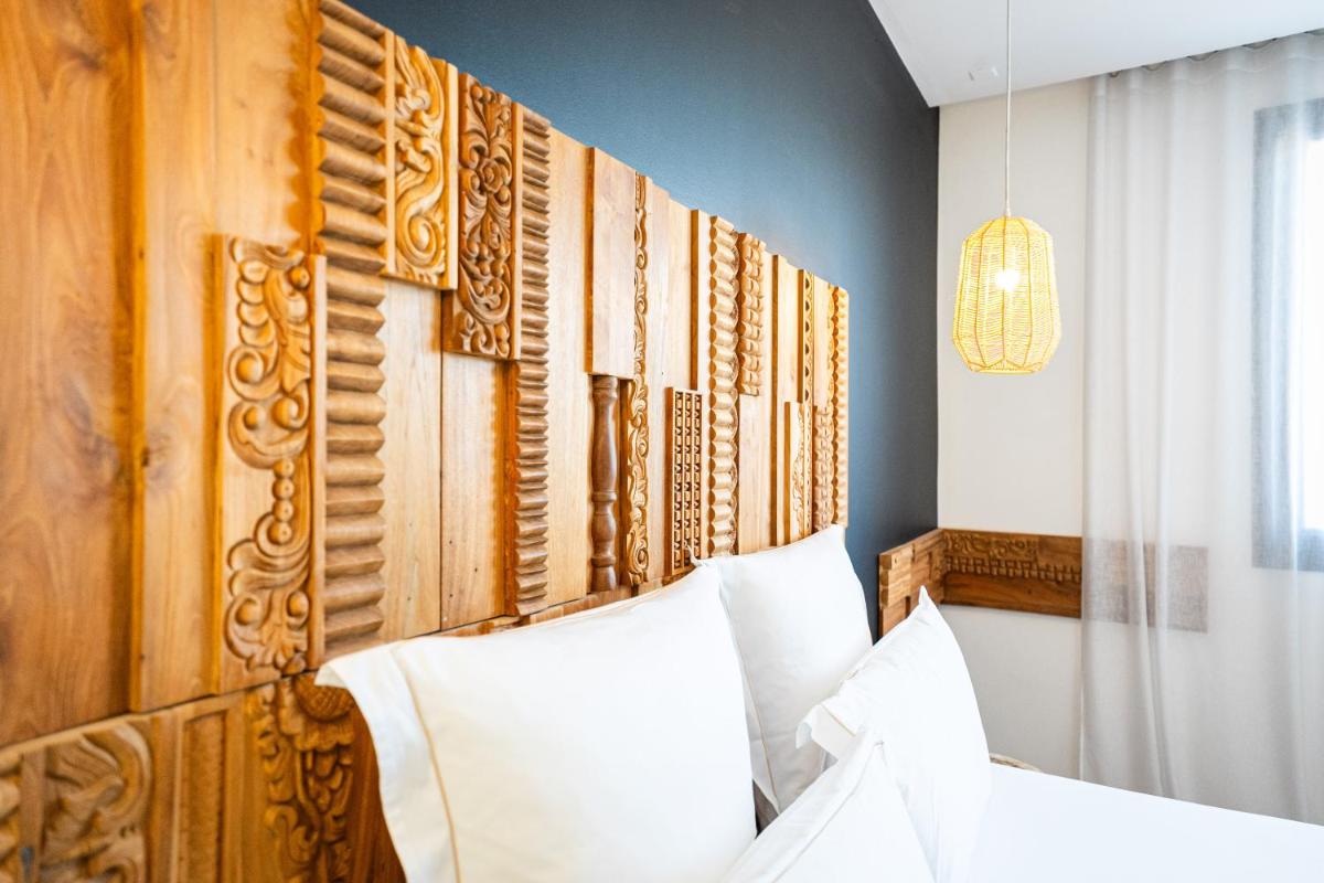 Un ou plusieurs lits dans un hébergement de l'établissement Hôtel Le Saint Remy & Spa