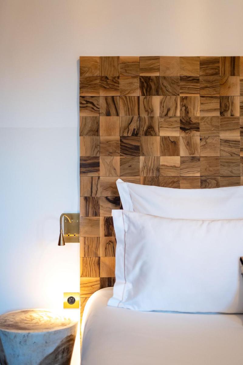 Un ou plusieurs lits dans un hébergement de l'établissement Hôtel Le Saint Remy & Spa