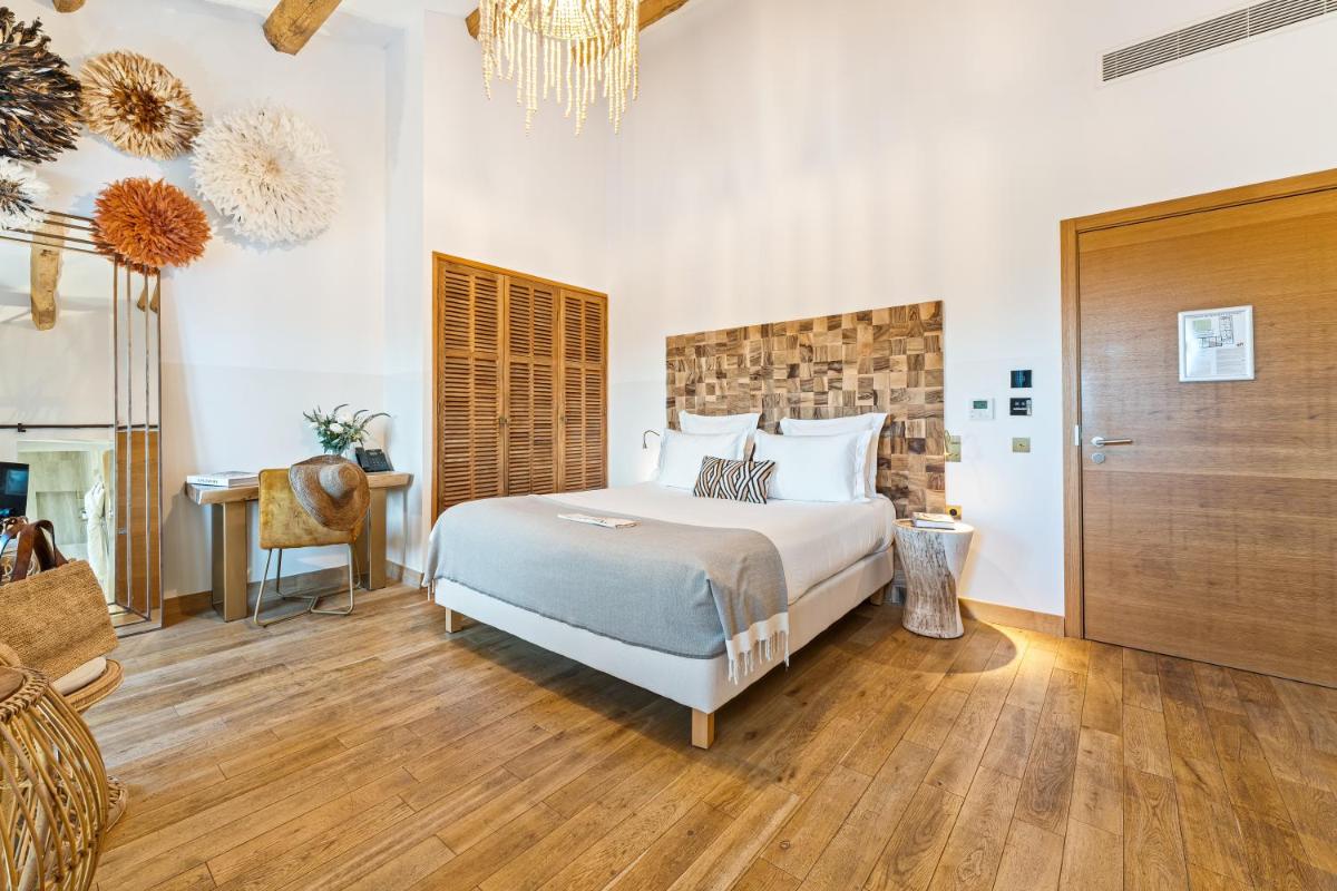Un ou plusieurs lits dans un hébergement de l'établissement Hôtel Le Saint Remy & Spa