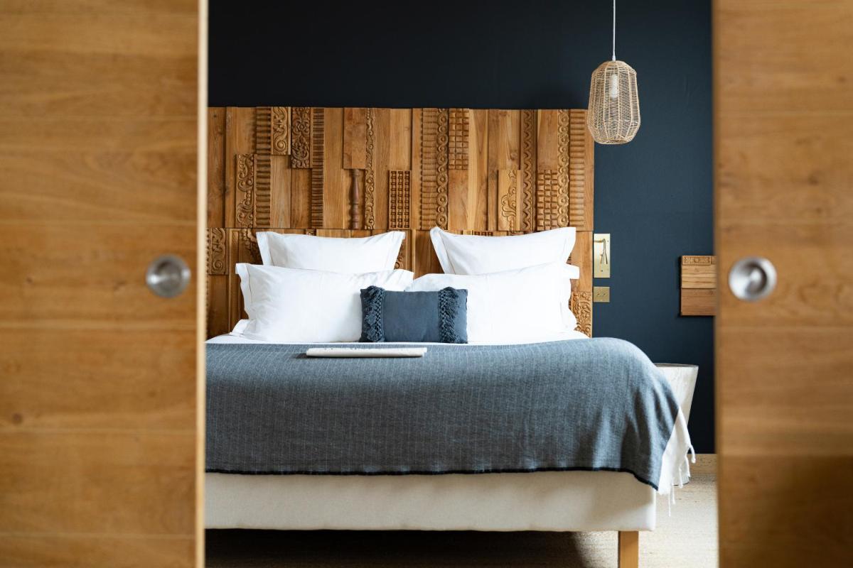Un ou plusieurs lits dans un hébergement de l'établissement Hôtel Le Saint Remy & Spa