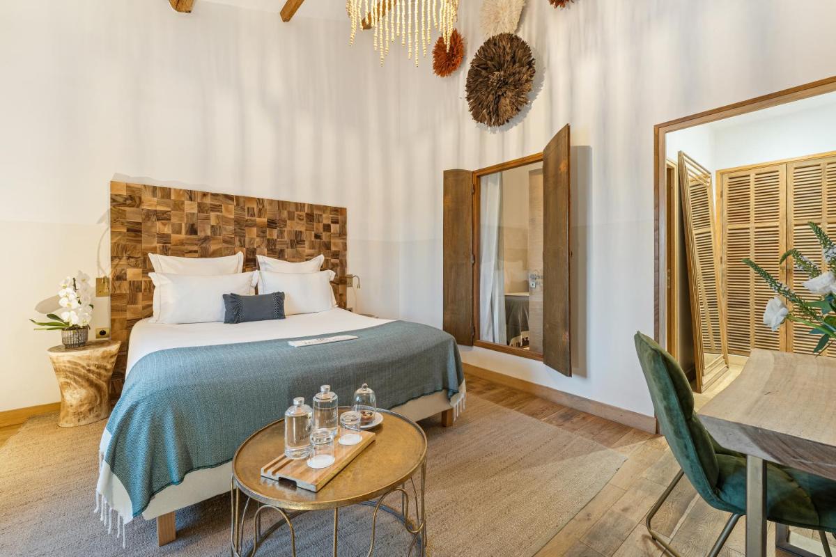 Un ou plusieurs lits dans un hébergement de l'établissement Hôtel Le Saint Remy & Spa