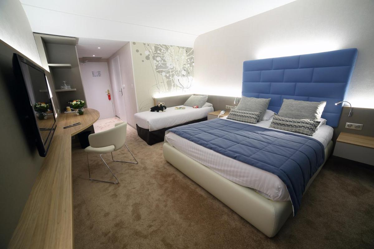Un ou plusieurs lits dans un hébergement de l'établissement Hotel Plaza - site du Futuroscope