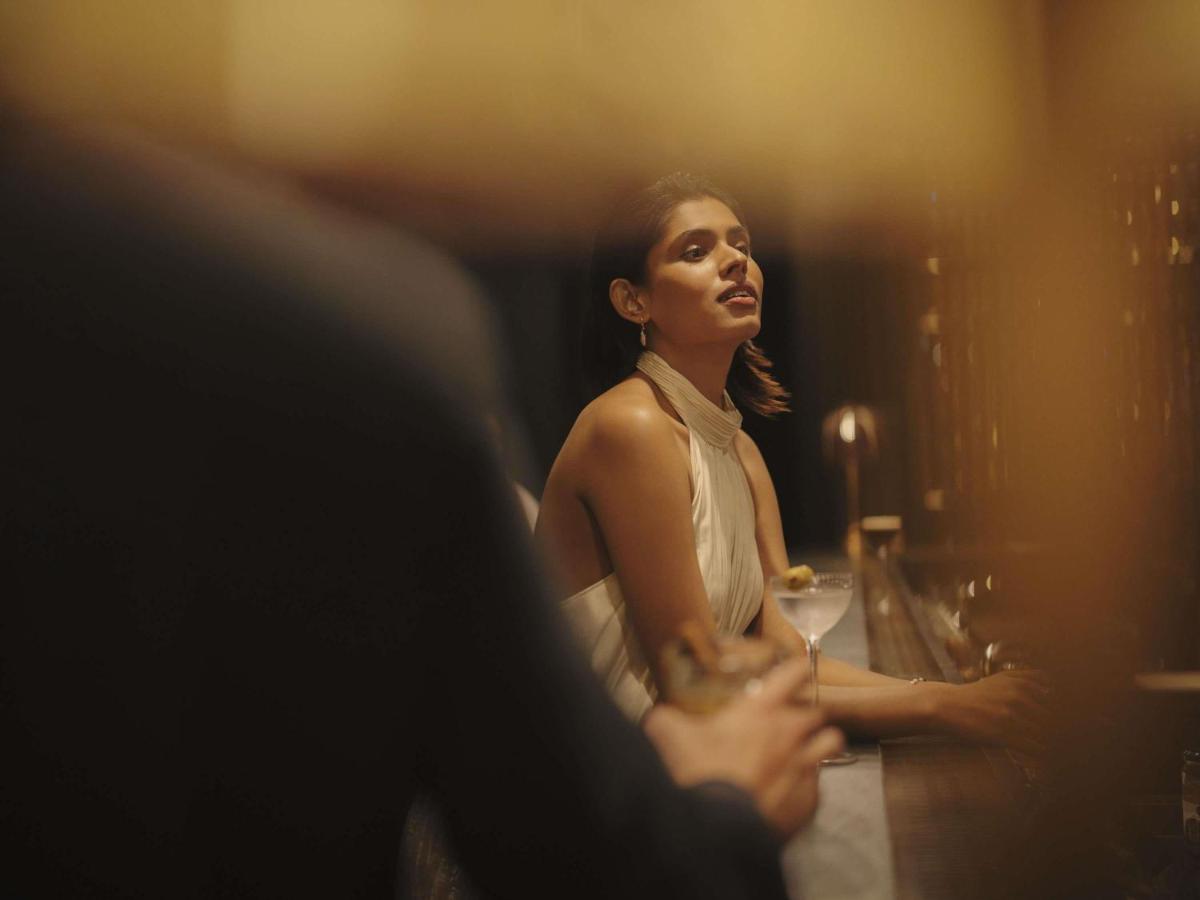 a woman sitting in front of a mirror at Fairmont Mumbai in Mumbai