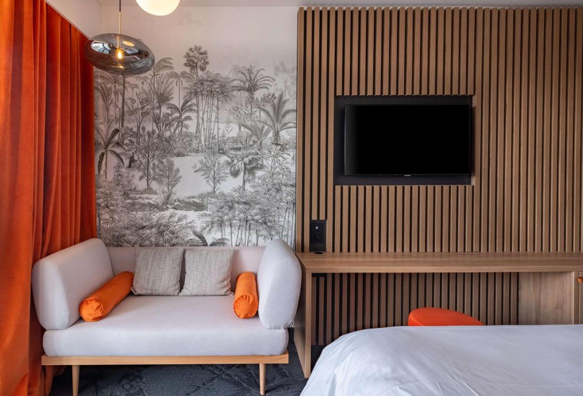 Un ou plusieurs lits dans un hébergement de l'établissement GOLDEN TULIP LYON OUEST TECHLID Hotel & Spa