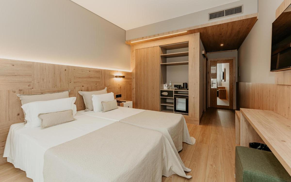 Uma cama ou camas num quarto em Hotel Minho