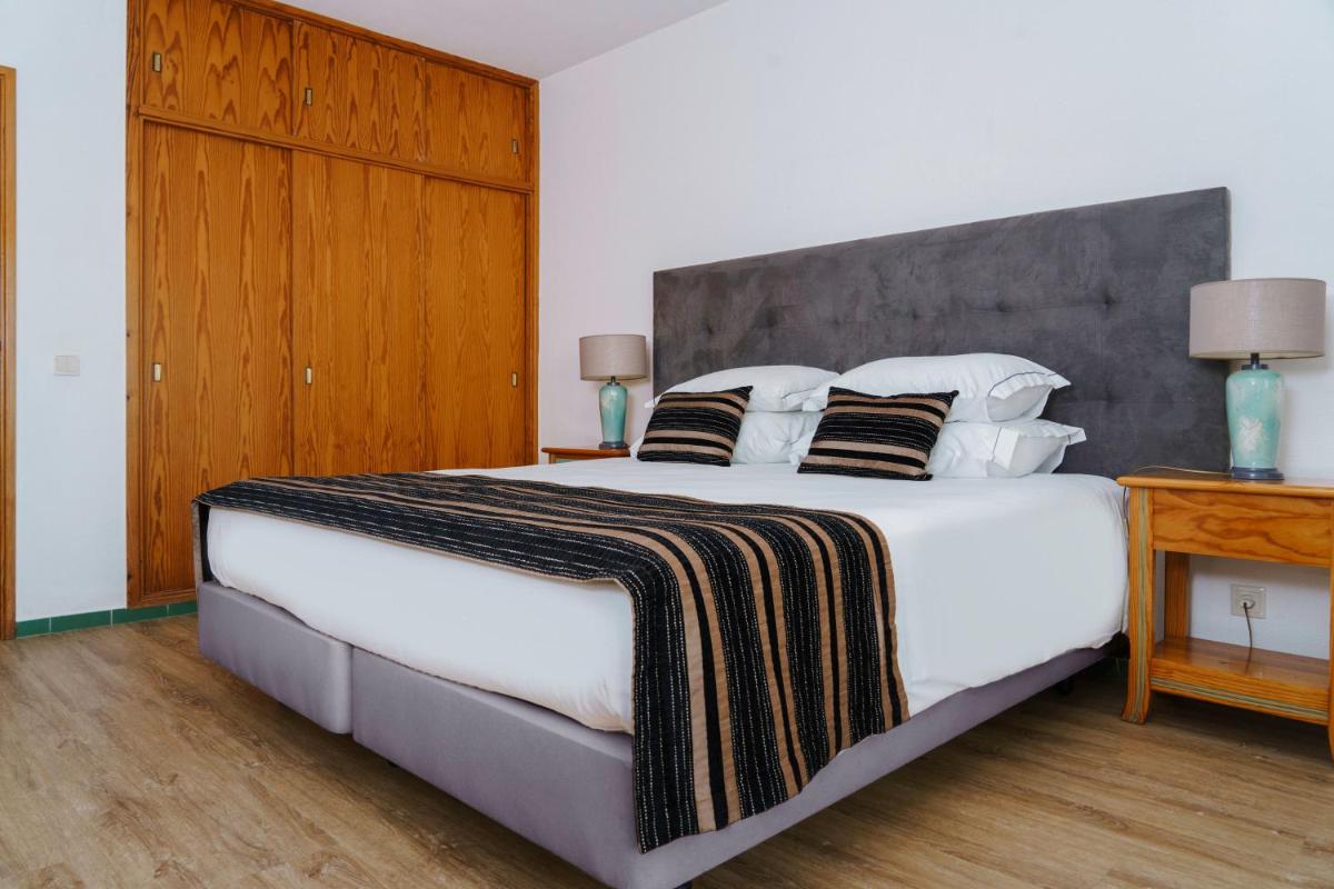 Uma cama ou camas num quarto em Luna Hotel da Oura