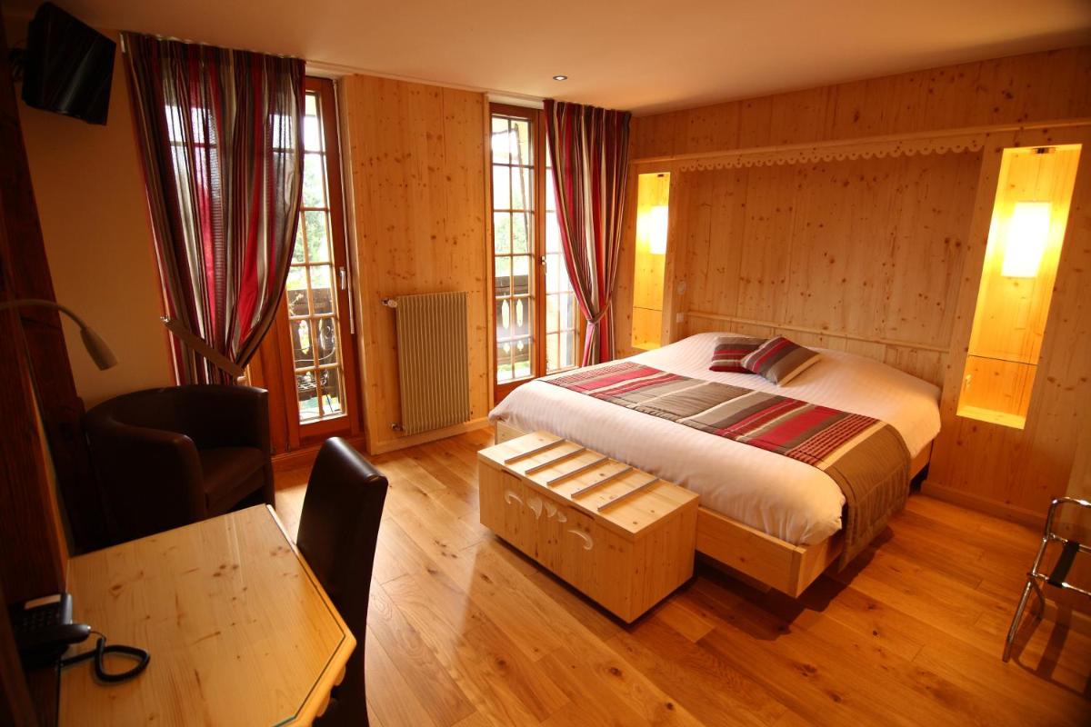 Un ou plusieurs lits dans un hébergement de l'établissement LE CLOS DES SOURCES Hôtel & Spa