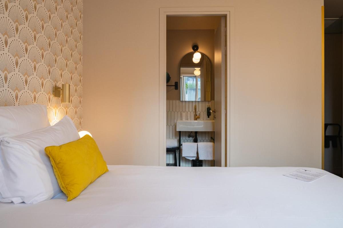 Un ou plusieurs lits dans un hébergement de l'établissement Hôtel Artemisia Montmartre