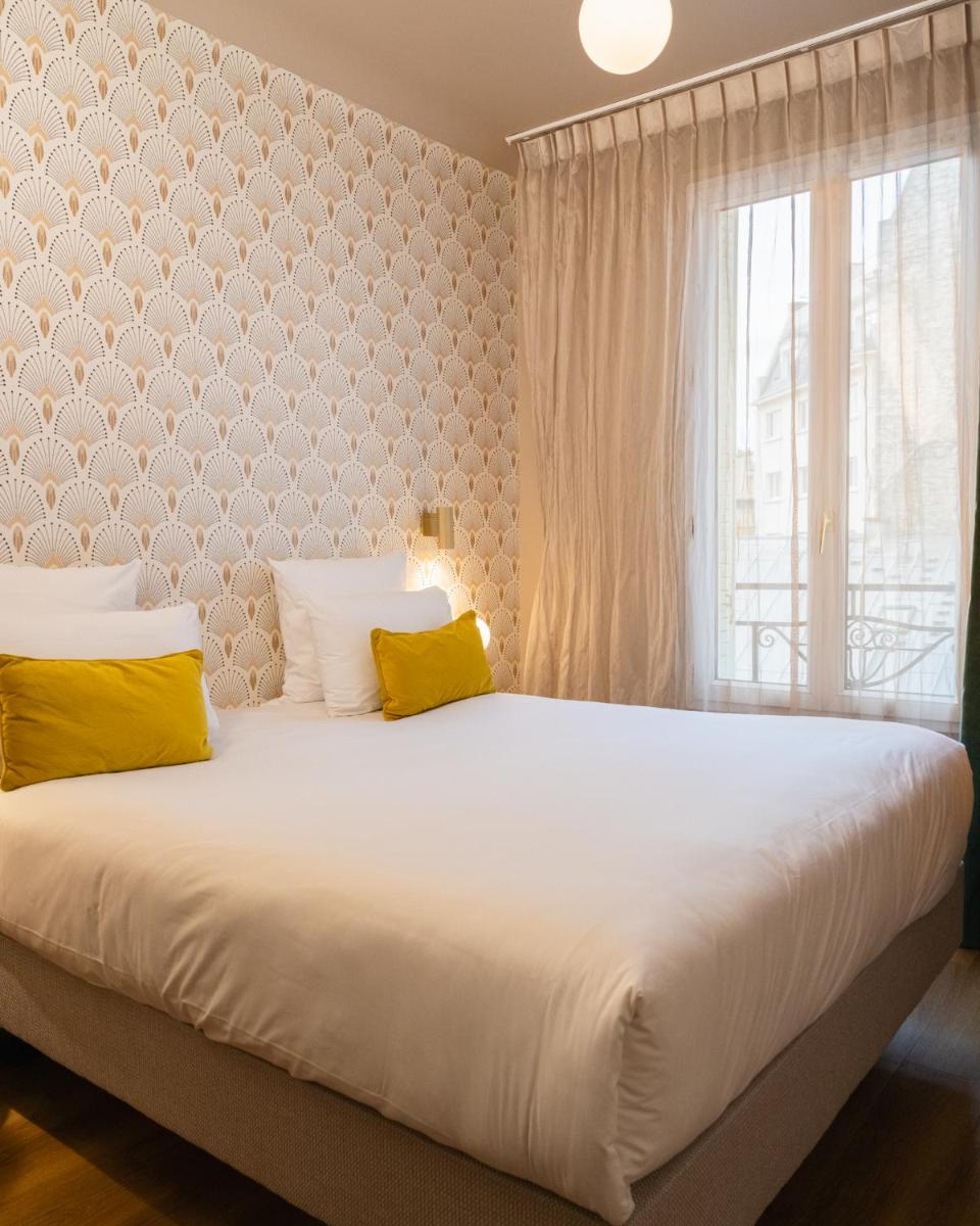 Un ou plusieurs lits dans un hébergement de l'établissement Hôtel Artemisia Montmartre