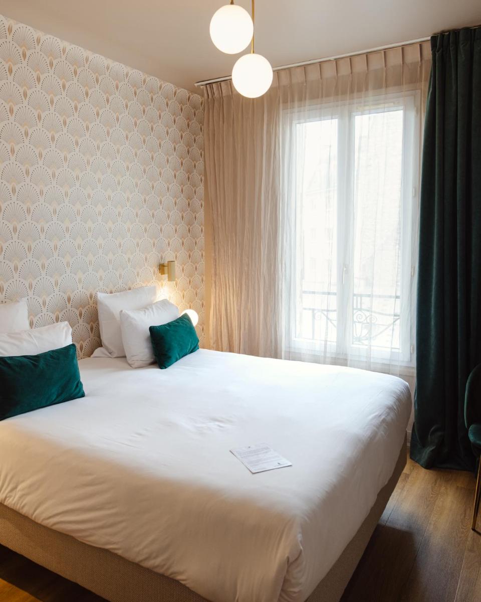 Un ou plusieurs lits dans un hébergement de l'établissement Hôtel Artemisia Montmartre