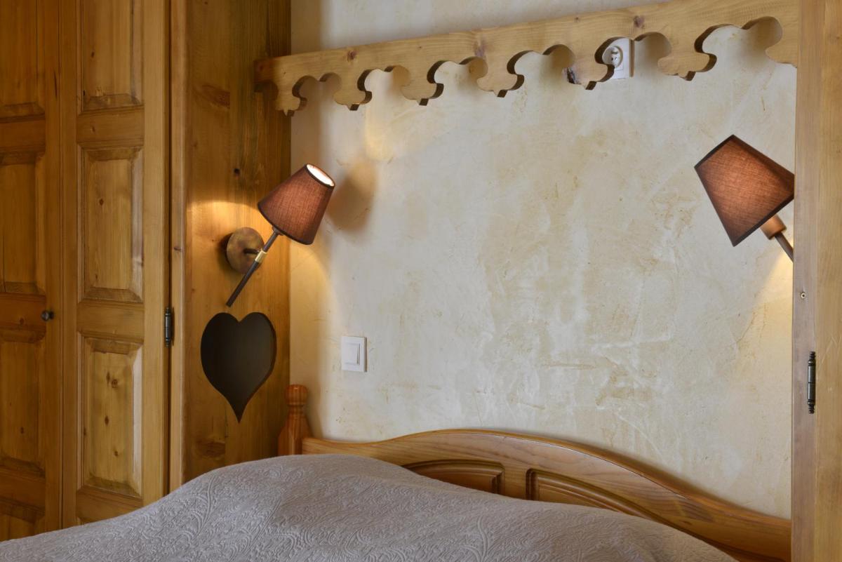 Un ou plusieurs lits dans un hébergement de l'établissement Hotel Le Ferraillon