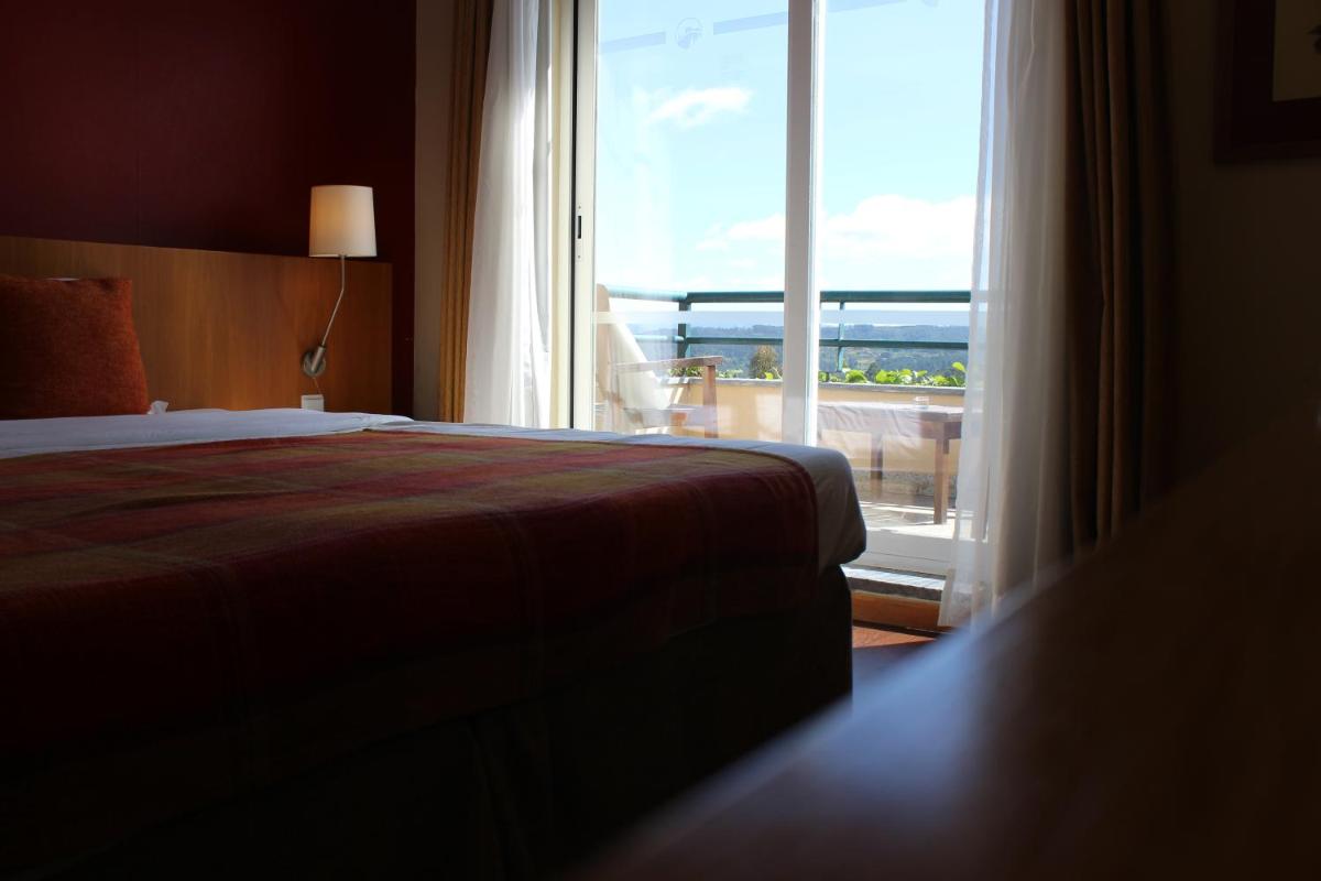 Uma cama ou camas num quarto em Hotel Da Montanha