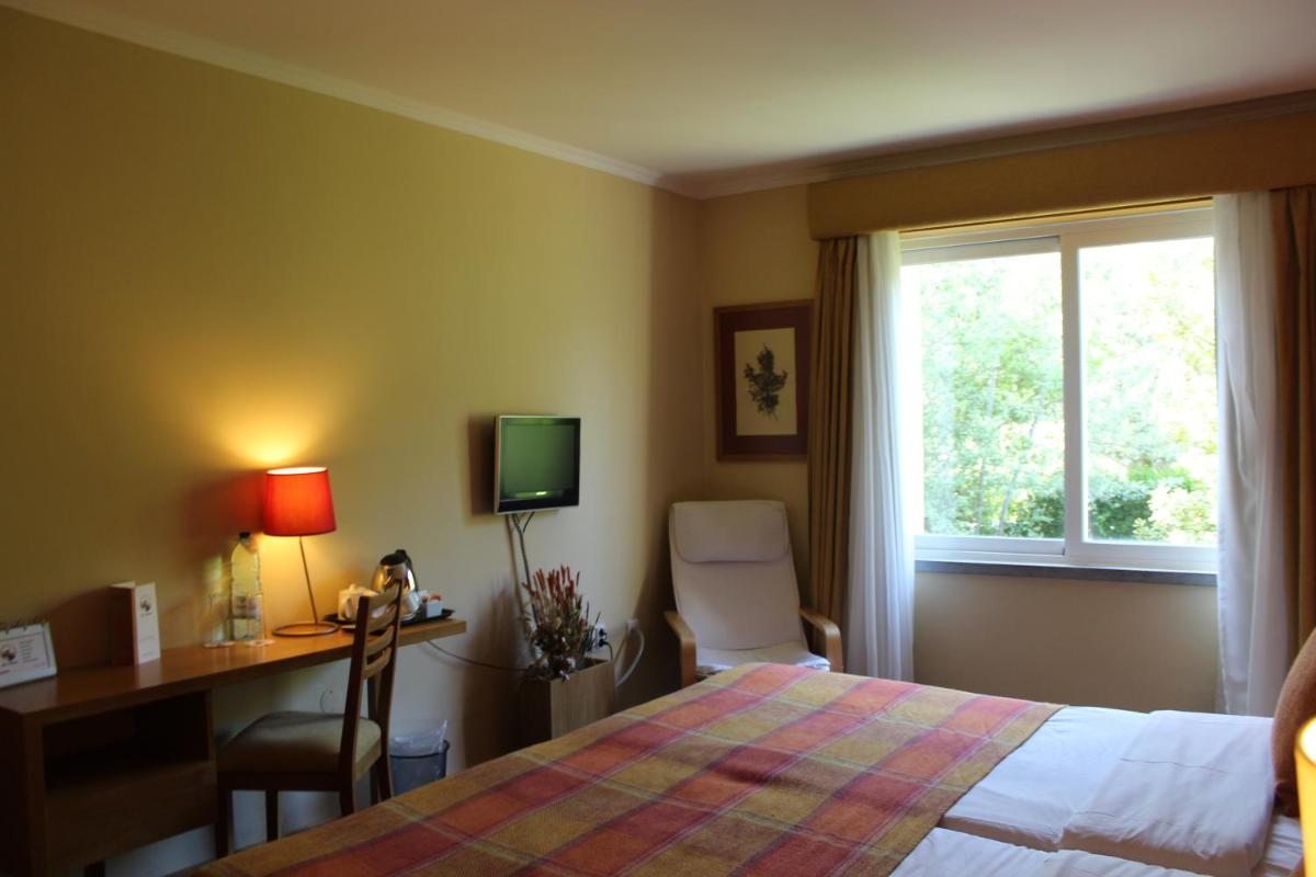 Uma cama ou camas num quarto em Hotel Da Montanha