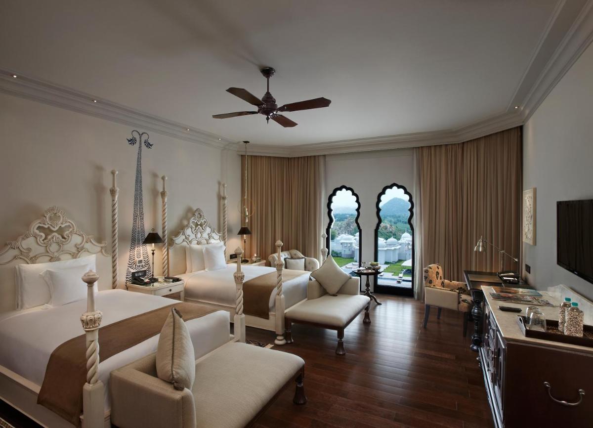 a large bedroom with two beds and a ceiling fan at Fairmont Jaipur in Jaipur