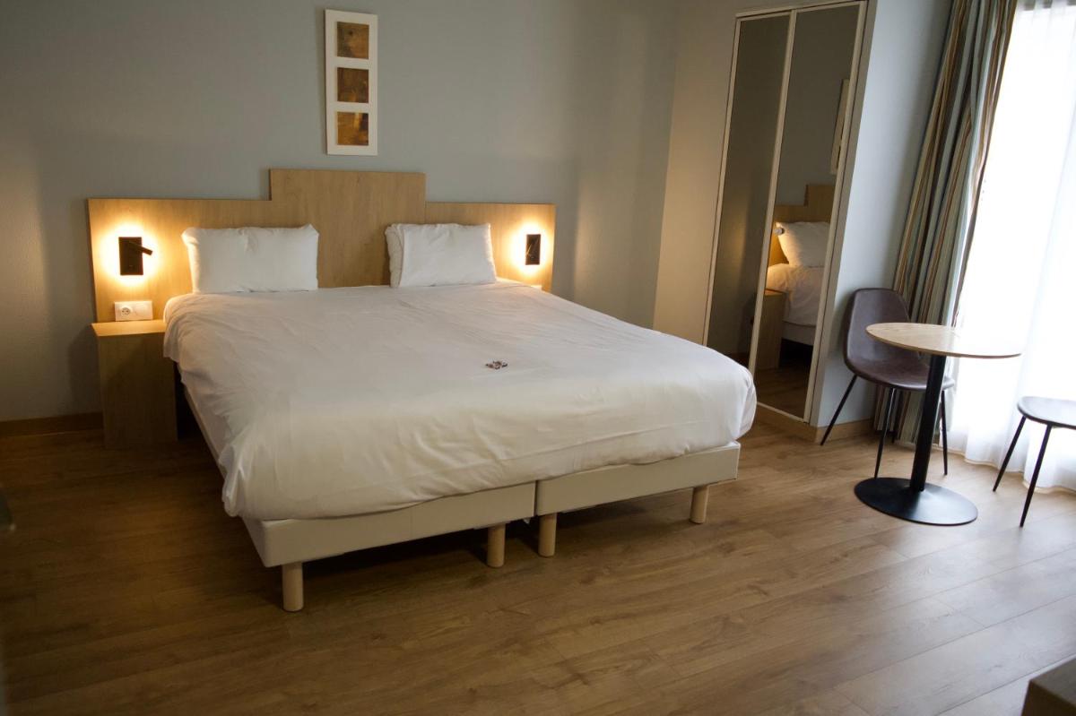Un ou plusieurs lits dans un hébergement de l'établissement Tulip Inn Honfleur Residence & Spa