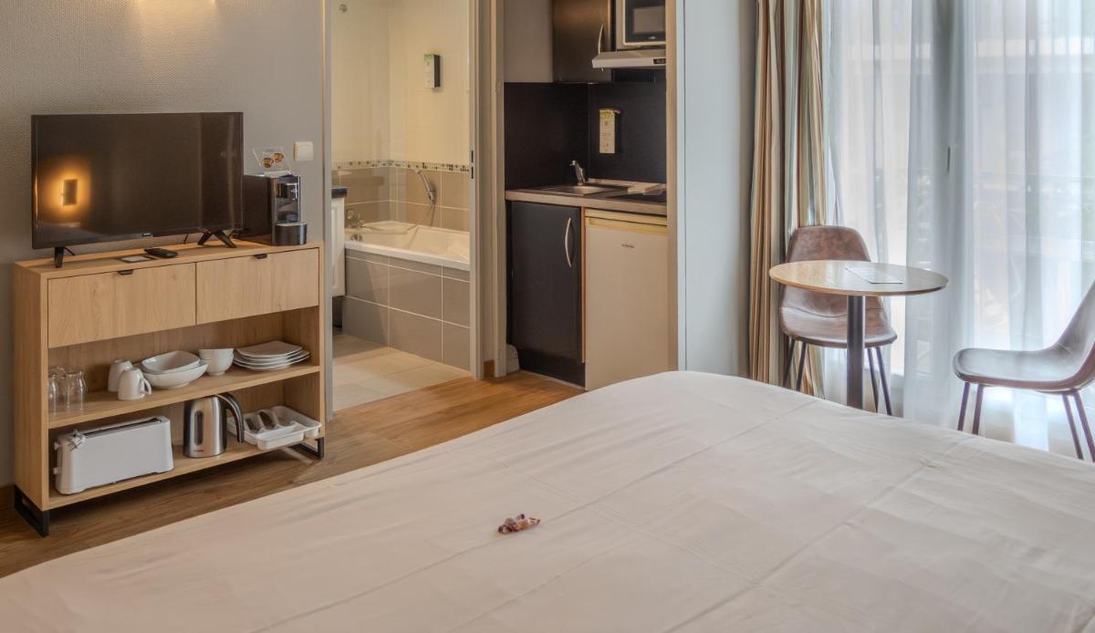 Un ou plusieurs lits dans un hébergement de l'établissement Tulip Inn Honfleur Residence & Spa