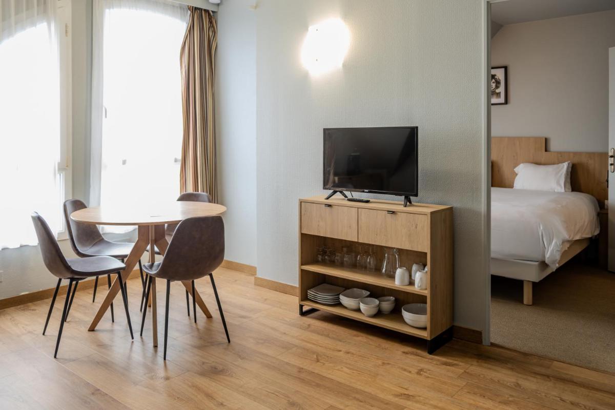une chambre avec un lit, une table et une télévision dans l'établissement Tulip Inn Honfleur Residence & Spa, à Honfleur