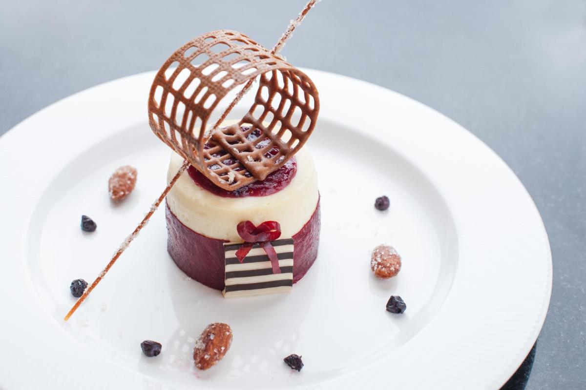 a dessert on a white plate on a table at Feathers- A Radha Hotel, Chennai in Chennai