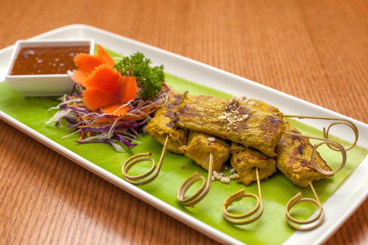 a plate of food with meat and vegetables on a table at Feathers- A Radha Hotel, Chennai in Chennai