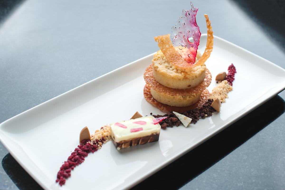a white plate with a dessert on a table at Feathers- A Radha Hotel, Chennai in Chennai