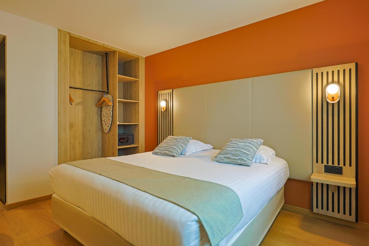 Un ou plusieurs lits dans un hébergement de l'établissement Seven Urban Suites Nantes Centre