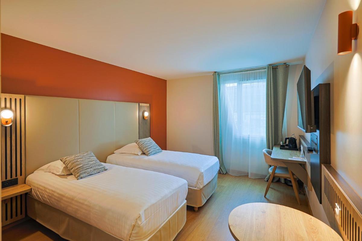 Un ou plusieurs lits dans un hébergement de l'établissement Seven Urban Suites Nantes Centre