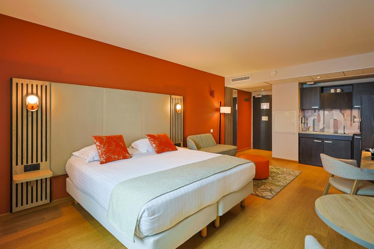 Un ou plusieurs lits dans un hébergement de l'établissement Seven Urban Suites Nantes Centre