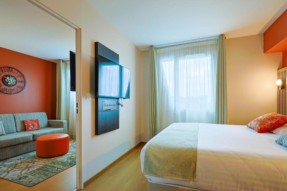 Un ou plusieurs lits dans un hébergement de l'établissement Seven Urban Suites Nantes Centre