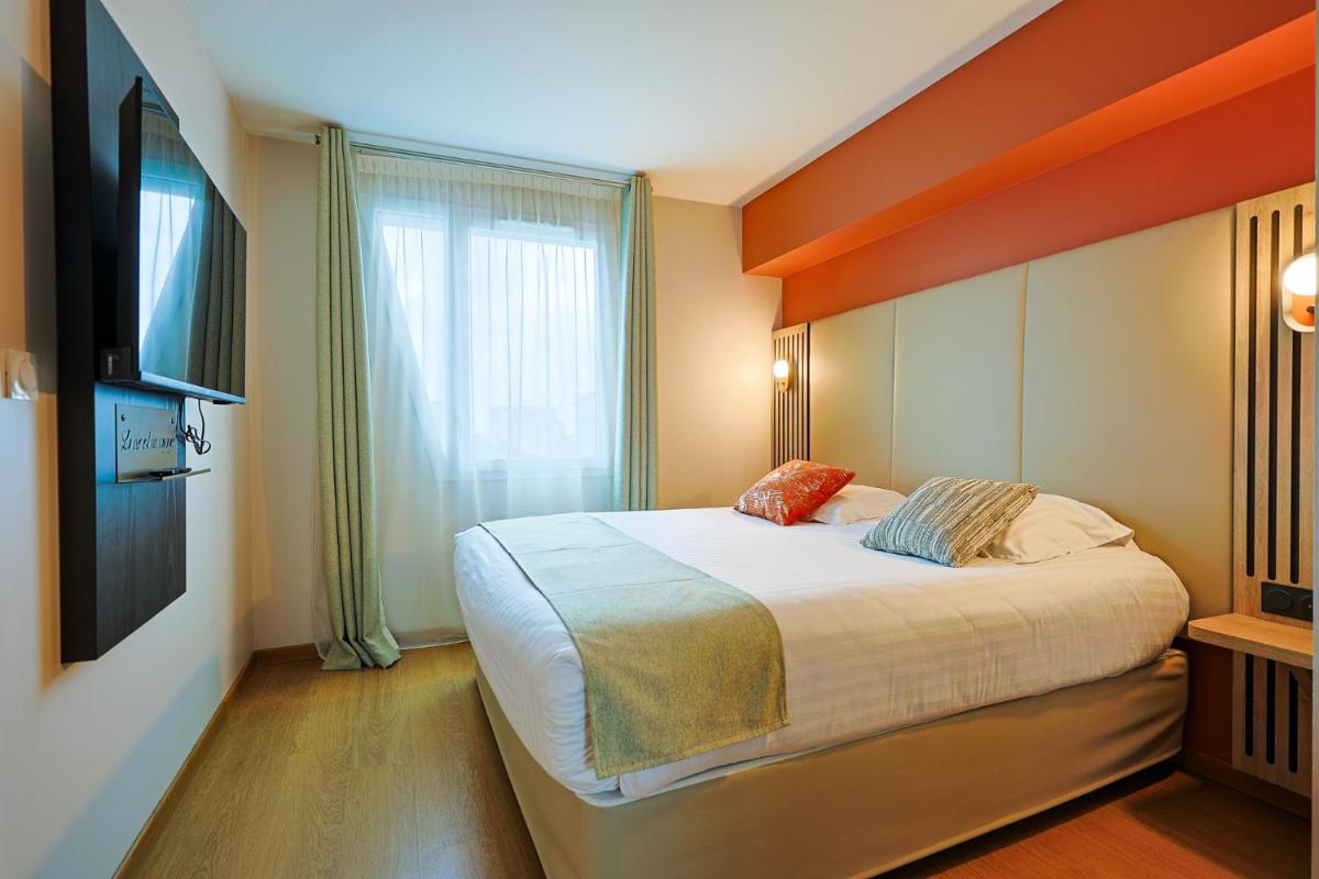 Un ou plusieurs lits dans un hébergement de l'établissement Seven Urban Suites Nantes Centre