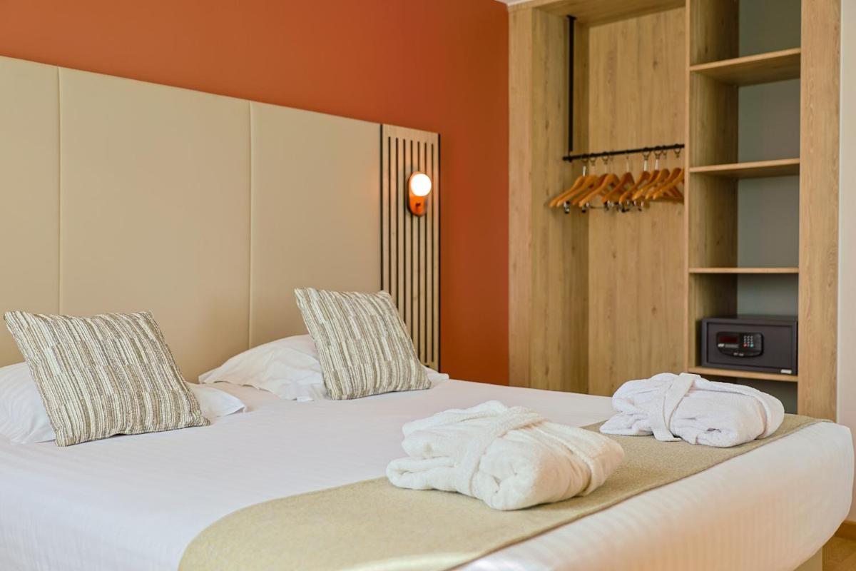 deux serviettes sur un lit dans une chambre dans l'établissement Seven Urban Suites Nantes Centre, à Nantes 56 autres photos