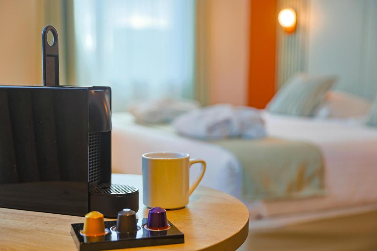 Un ou plusieurs lits dans un hébergement de l'établissement Seven Urban Suites Nantes Centre