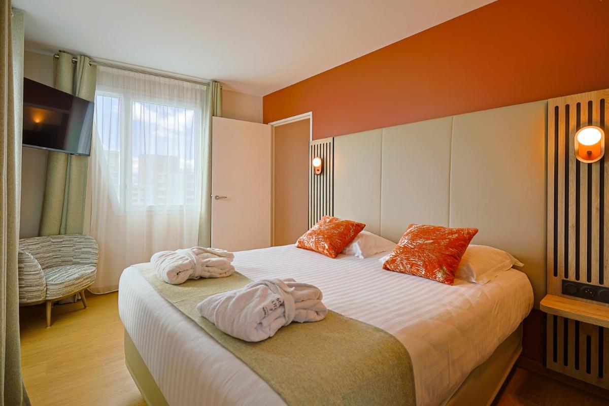 Un ou plusieurs lits dans un hébergement de l'établissement Seven Urban Suites Nantes Centre
