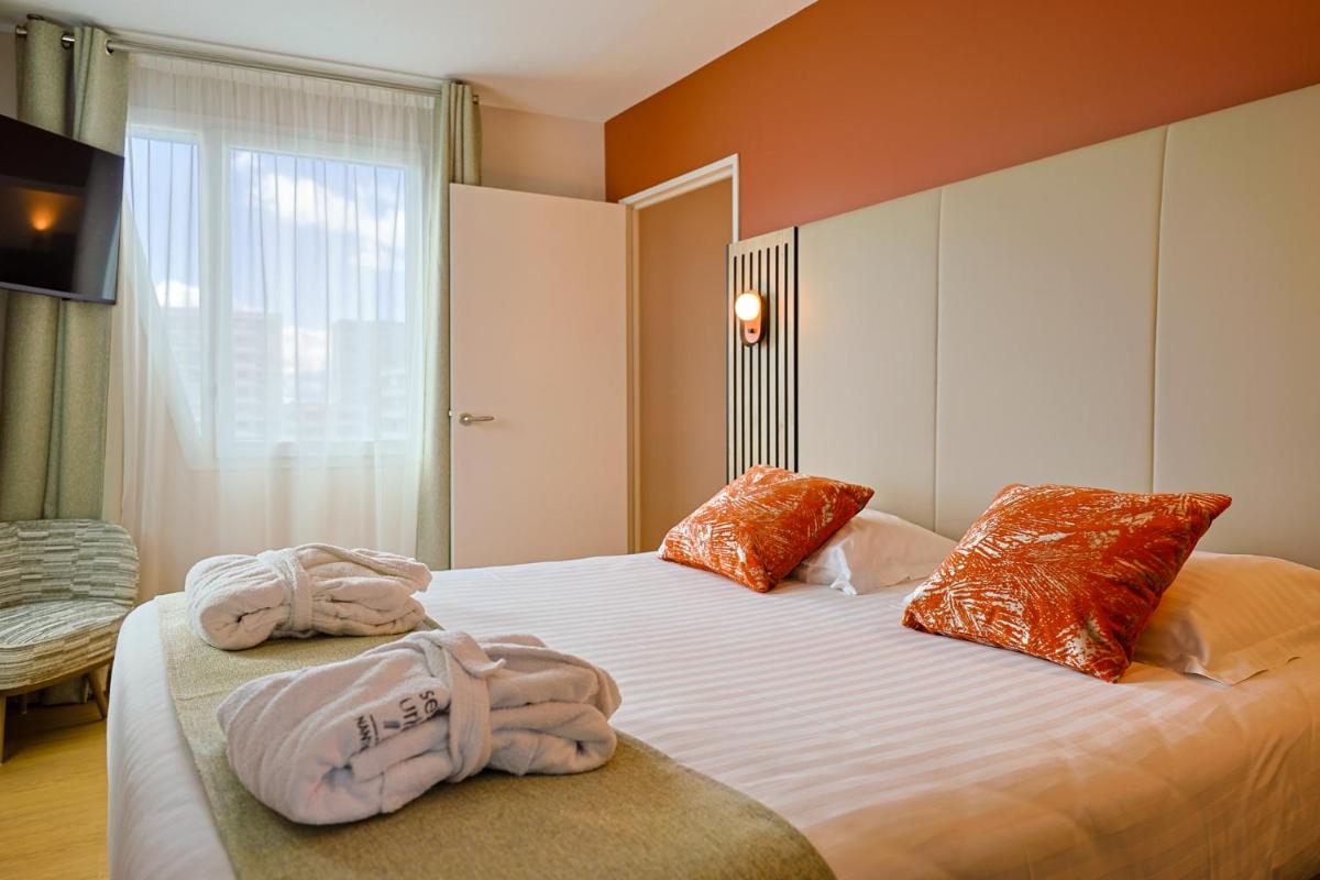 Un ou plusieurs lits dans un hébergement de l'établissement Seven Urban Suites Nantes Centre