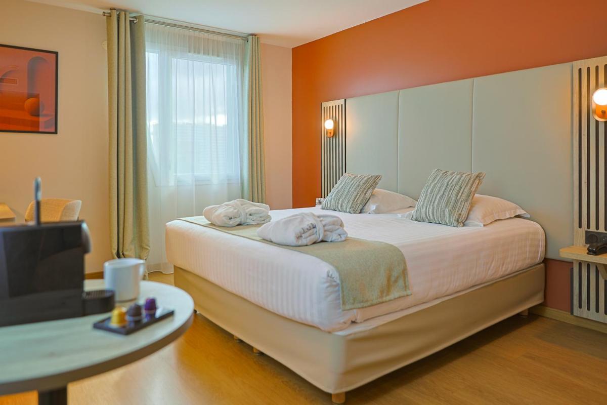 Un ou plusieurs lits dans un hébergement de l'établissement Seven Urban Suites Nantes Centre